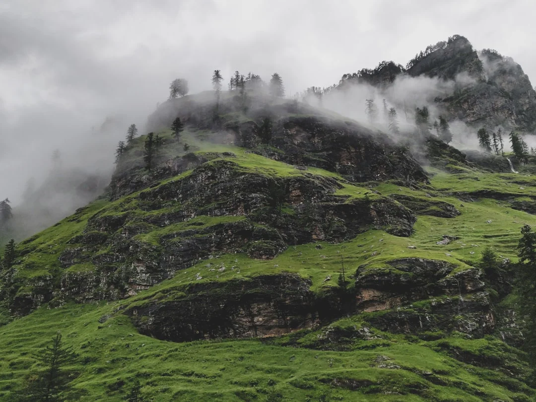 Gentle mountains and valleys shrouded in morning mist—a scene that illustrates the protective nature of the landscape