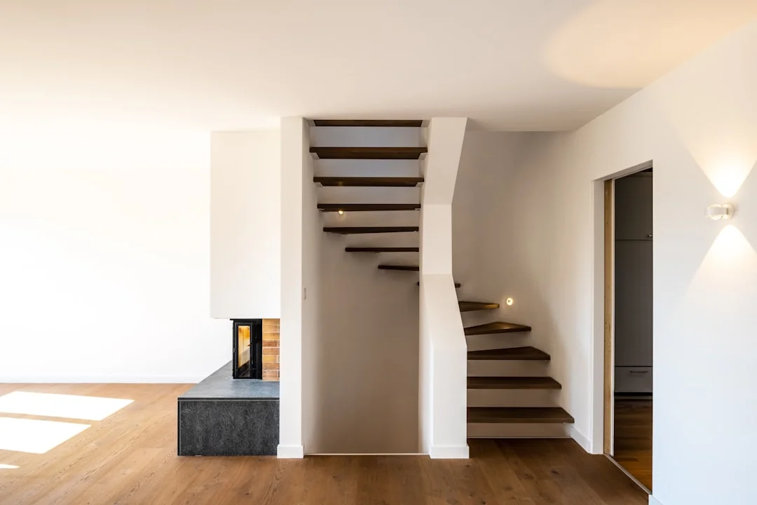 white wooden staircase near a white wall
