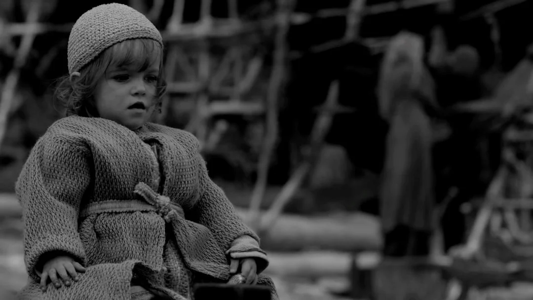 Child playing alone in a meadow - symbol of the inner child