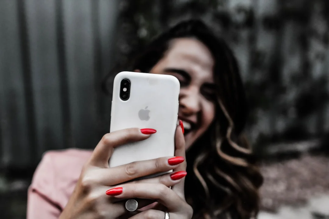 Young woman scrolls thoughtfully through her Instagram feed on her smartphone