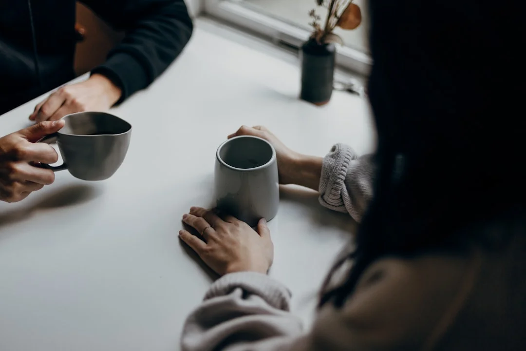 A couple chats casually over their morning coffee