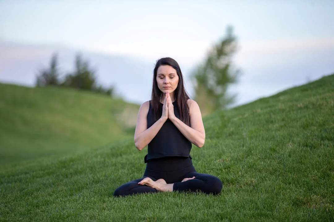 Woman in a serene meditative pose, symbolizing inner balance and chakra energy