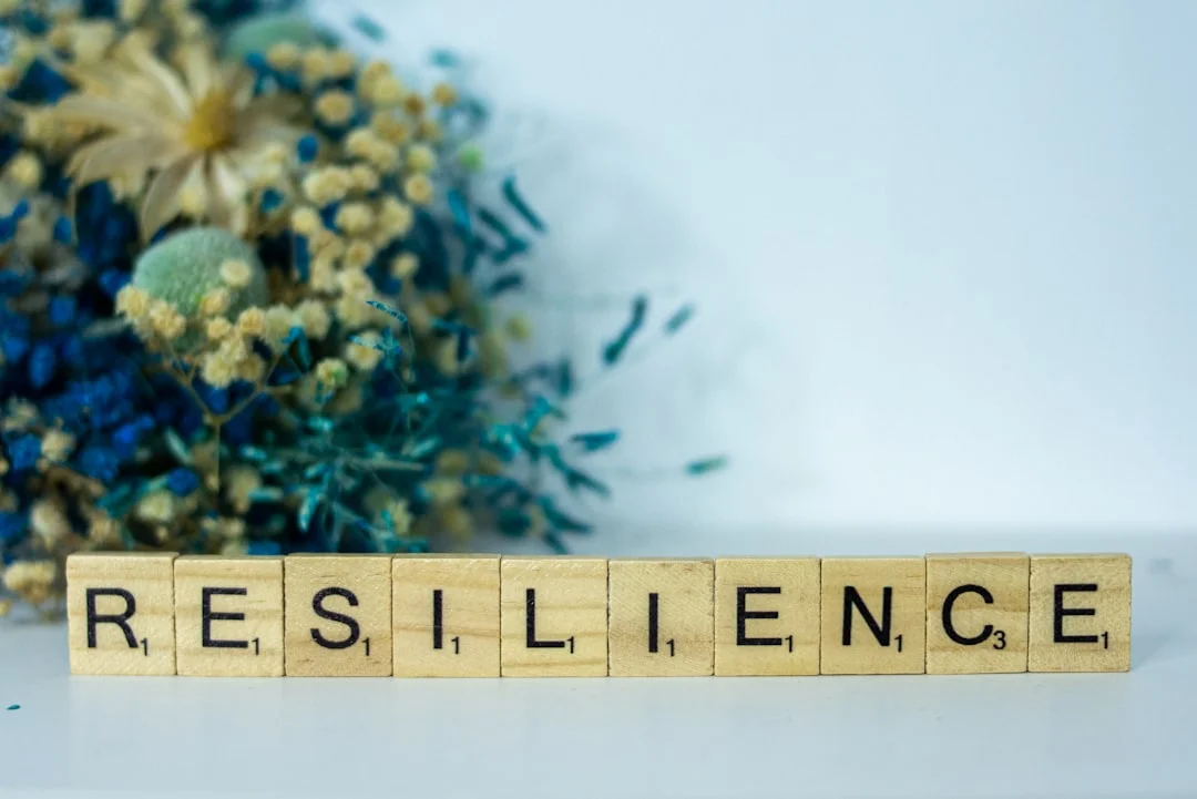 Woman sits calmly in nature and appears inwardly stable - symbol of psychological resilience