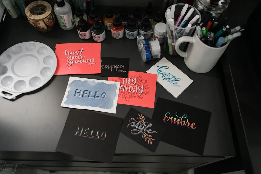 Colorful encouragement cards on a craft table, surrounded by pens and flowers