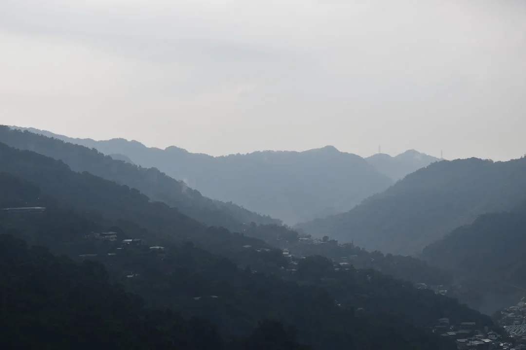 Gentle hills in the morning mist — the landscape surrounding a house