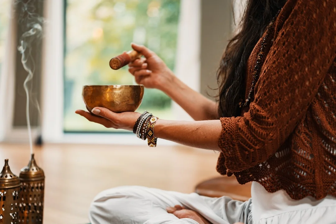 A singing bowl on a wooden table, soft lighting, a meditative atmosphere