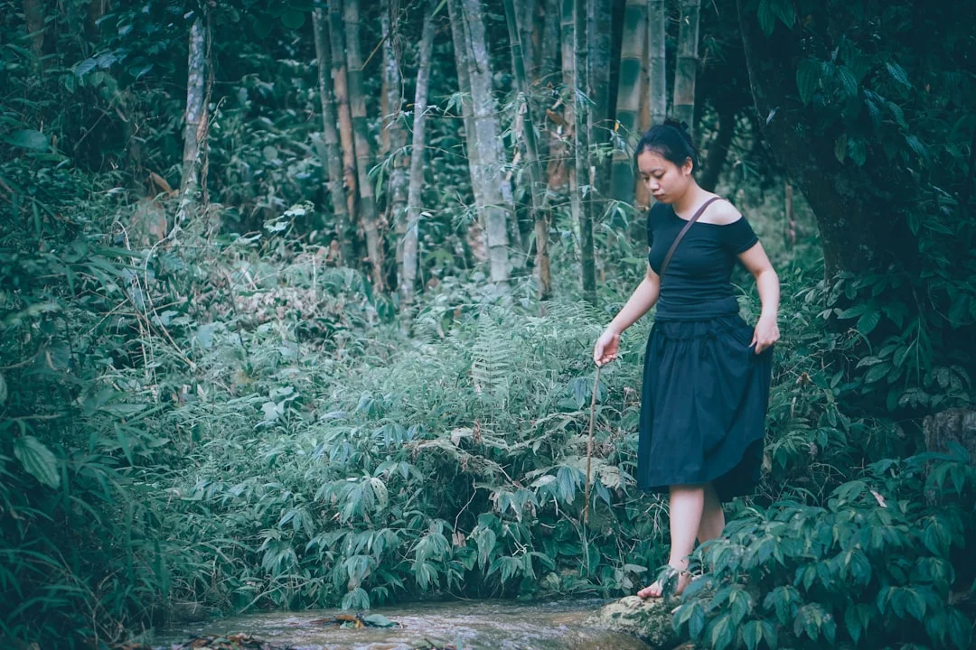 Woman walking quietly in nature - a symbol of lived body acceptance in everyday life