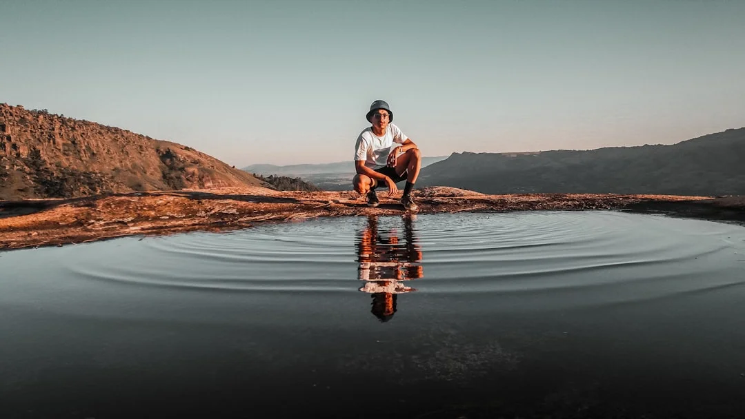 Woman sitting thoughtfully in nature - symbol of a meaningful life and eudaimonic well-being