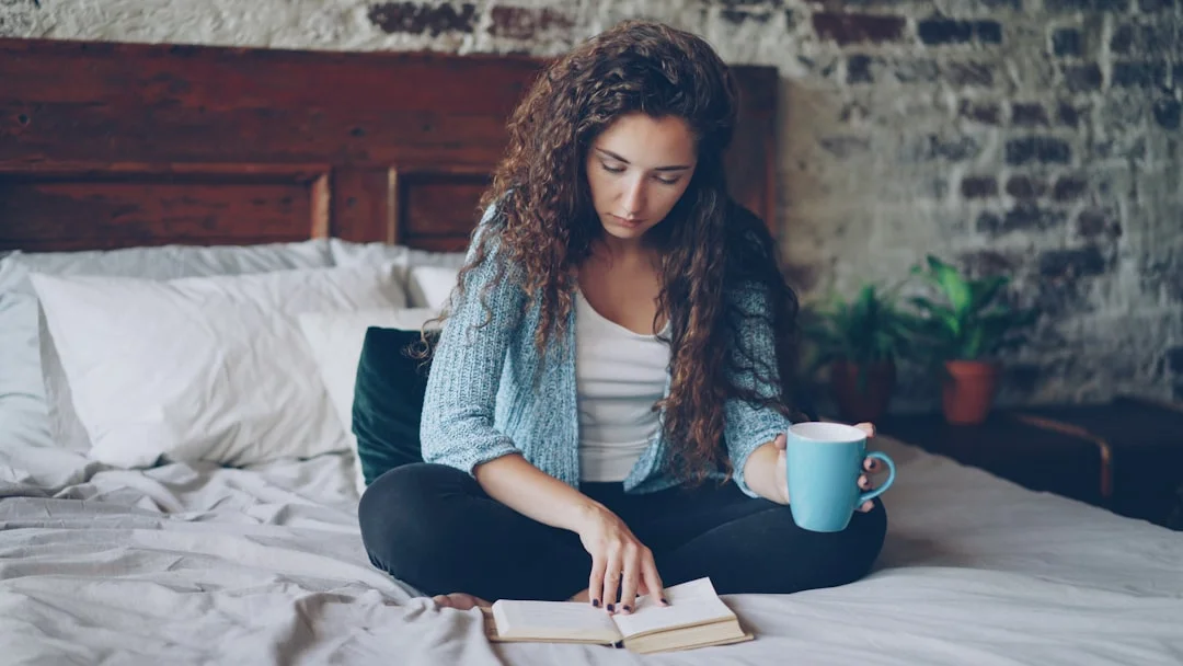 Woman reading a relaxed book on a quiet morning - self-care in everyday life